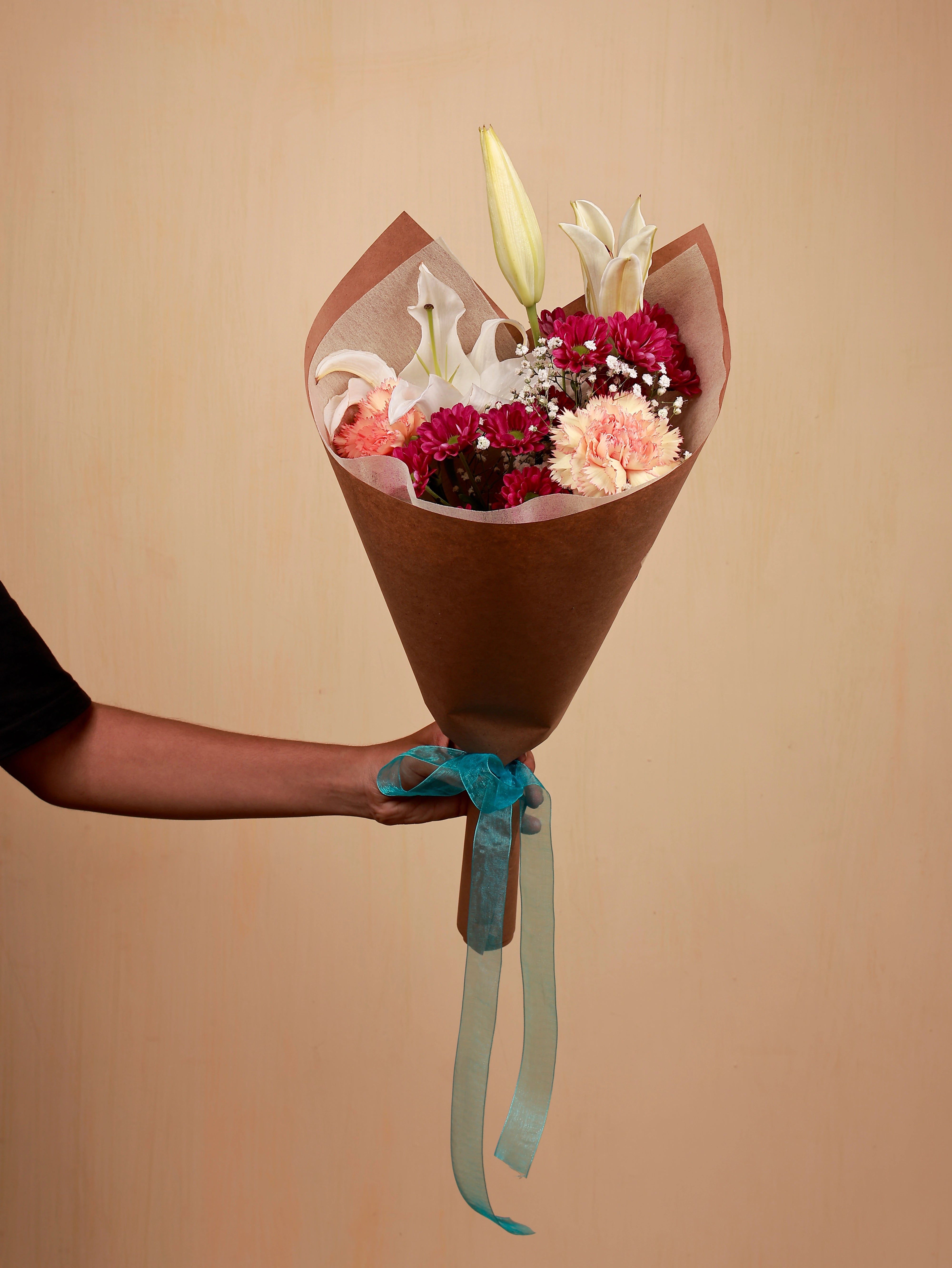 A mini bouquet of lily with carnation and santini